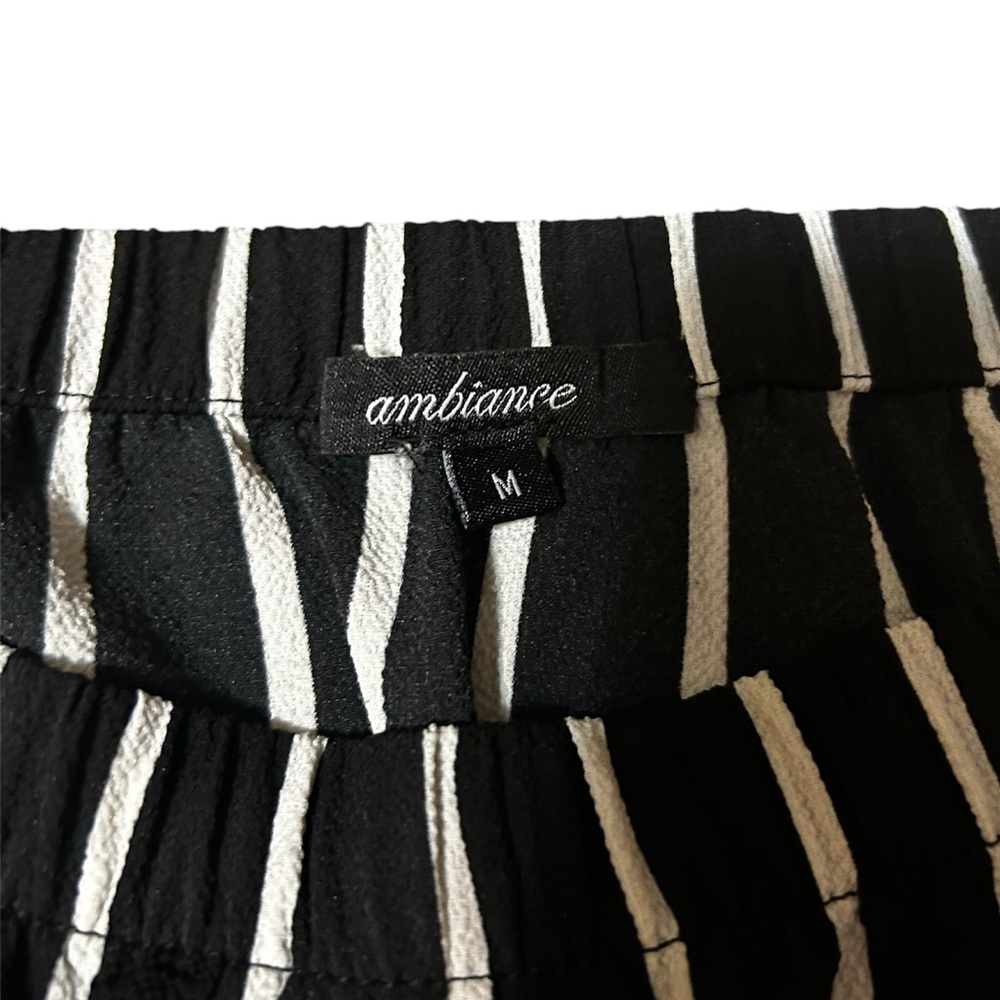 Black and white striped jumpsuit with flared leg and strapless top - Picture 3 of 3
